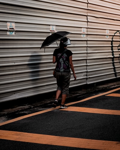 A woman walked beside the galvanized sheet
